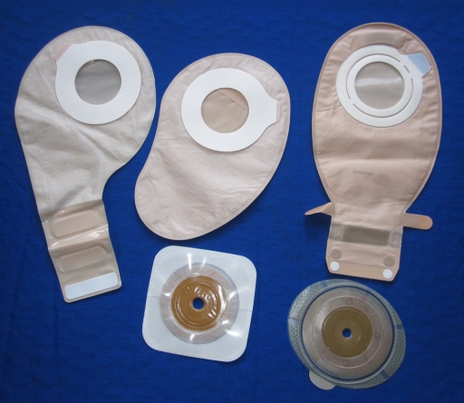 In adhesive coupling two-piece systems, the wafers and pouches stick together with an sticky ring. They are low profile, but I find them messy to swap out when on outdoor trips.