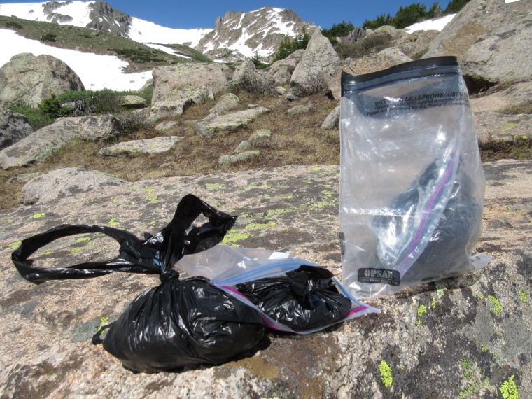 My pouch pack-out trifecta: the full pouch goes into a doggy-poo bag, that goes into a Ziplock, a few of those go into a Ziplock and than all of it gets placed into a re-usable OPSAK Odor-proof Bag. 